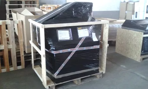 large wrapped item secured in wooden frame crate ready for transport